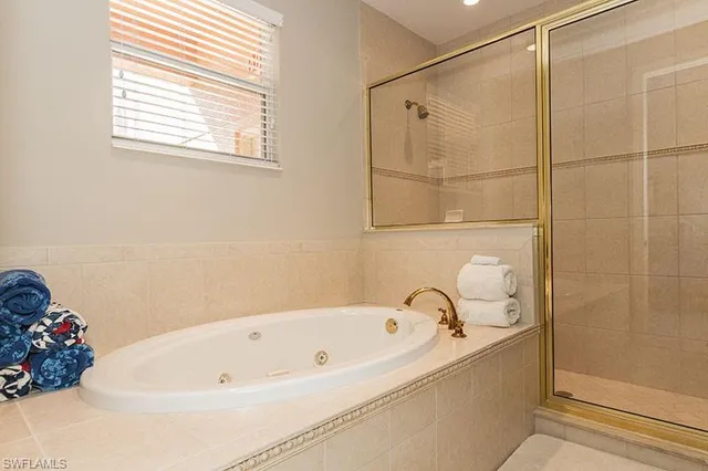 a bathroom with a bathtub and shower