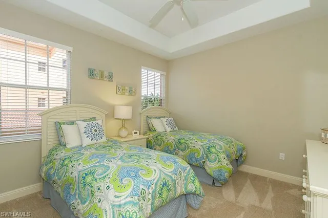 a bedroom with two beds and a window