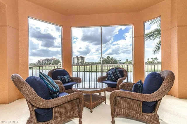 a living room with furniture and a floor to ceiling window