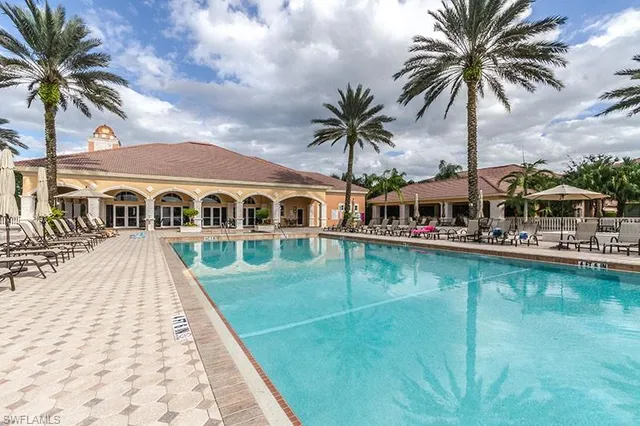 a front view of house with yard and swimming pool