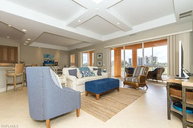 a living room with furniture and floor to ceiling window