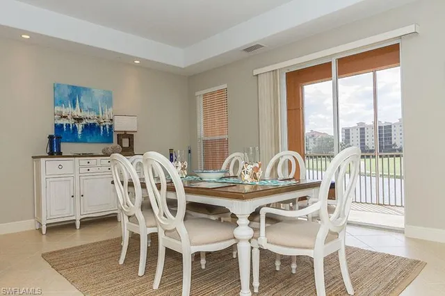 a dining room with furniture and window