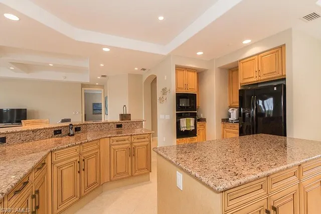 a kitchen with stainless steel appliances granite countertop a sink and cabinets