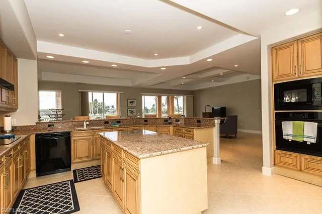 a kitchen with sink stove and cabinets