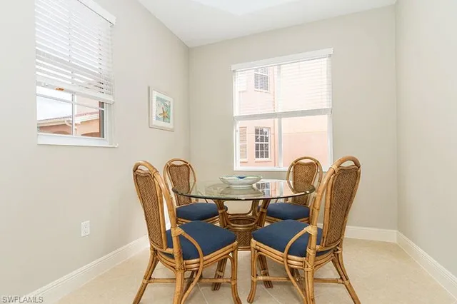 a dining room with furniture and windows