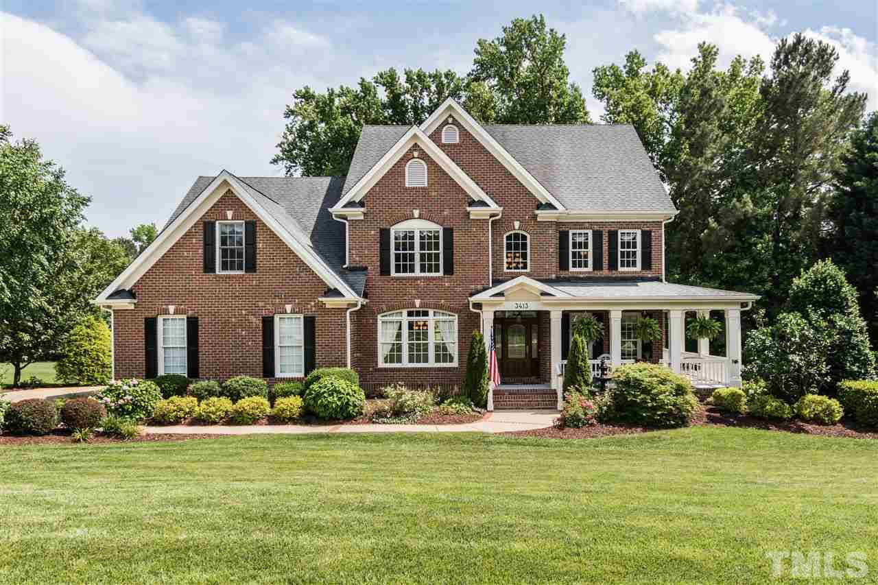 3413 Spartina Court Raleigh, NC 27606 - Photo 1 of 25 a front view of a house with a yard and potted plants