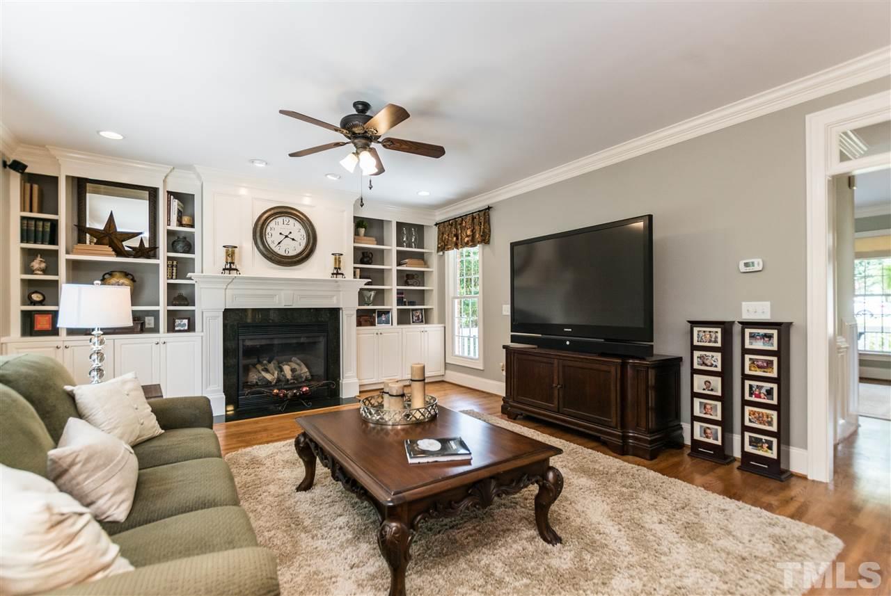3413 Spartina Court Raleigh, NC 27606 - Photo 12 of 25 a living room with furniture a rug and a fireplace