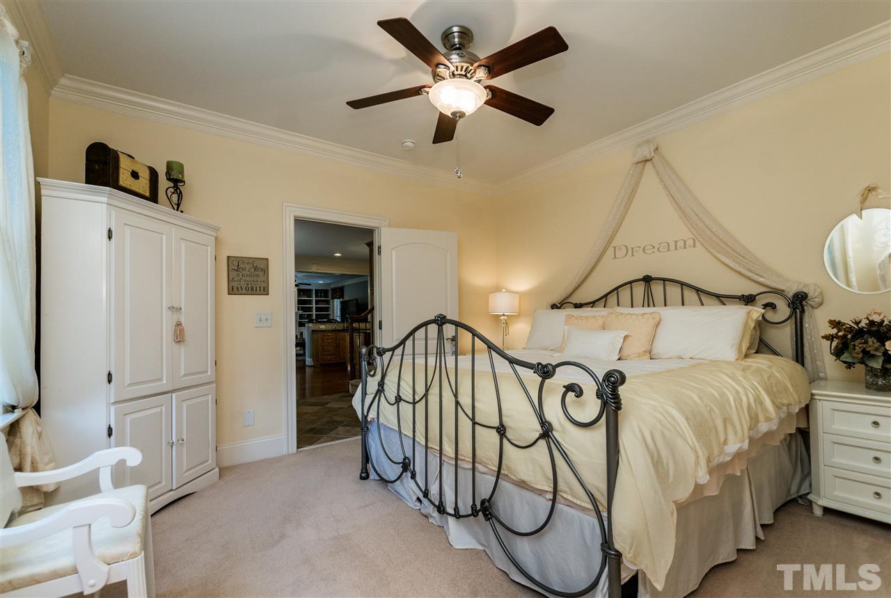 3413 Spartina Court Raleigh, NC 27606 - Photo 14 of 25 a bedroom with a bed and ceiling fan