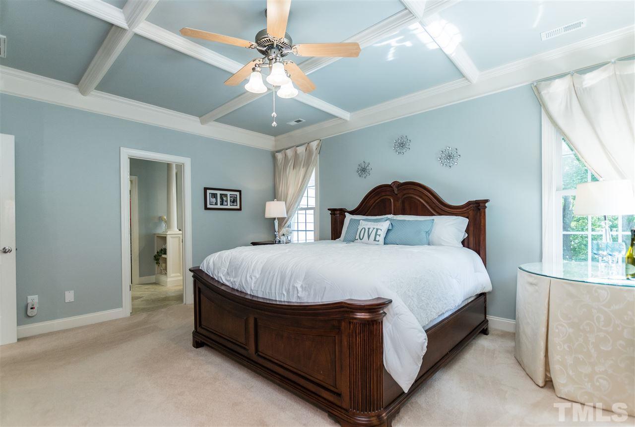 3413 Spartina Court Raleigh, NC 27606 - Photo 16 of 25 a spacious bedroom with a bed and a chandelier