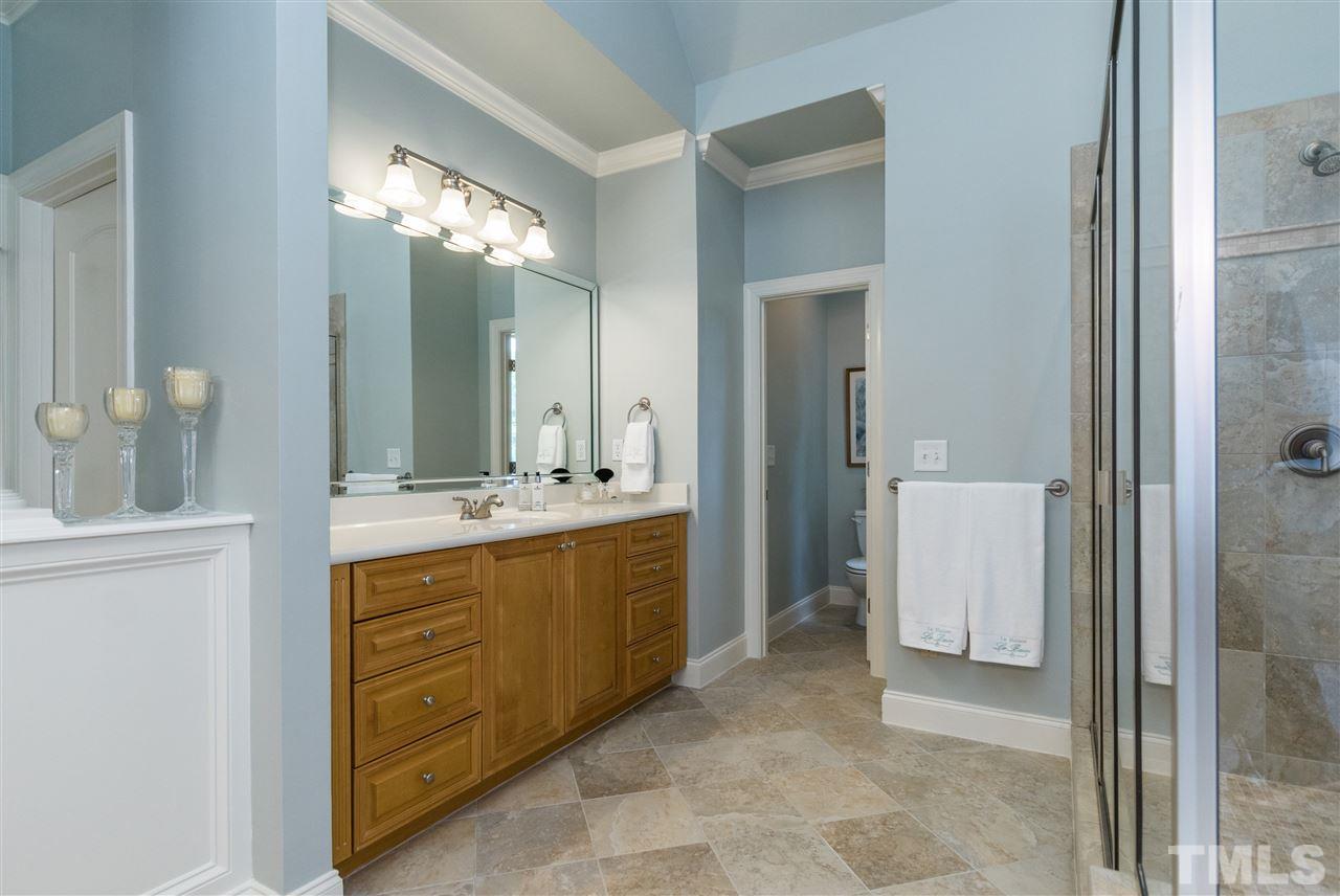 3413 Spartina Court Raleigh, NC 27606 - Photo 17 of 25 a bathroom with a double vanity sink and a mirror