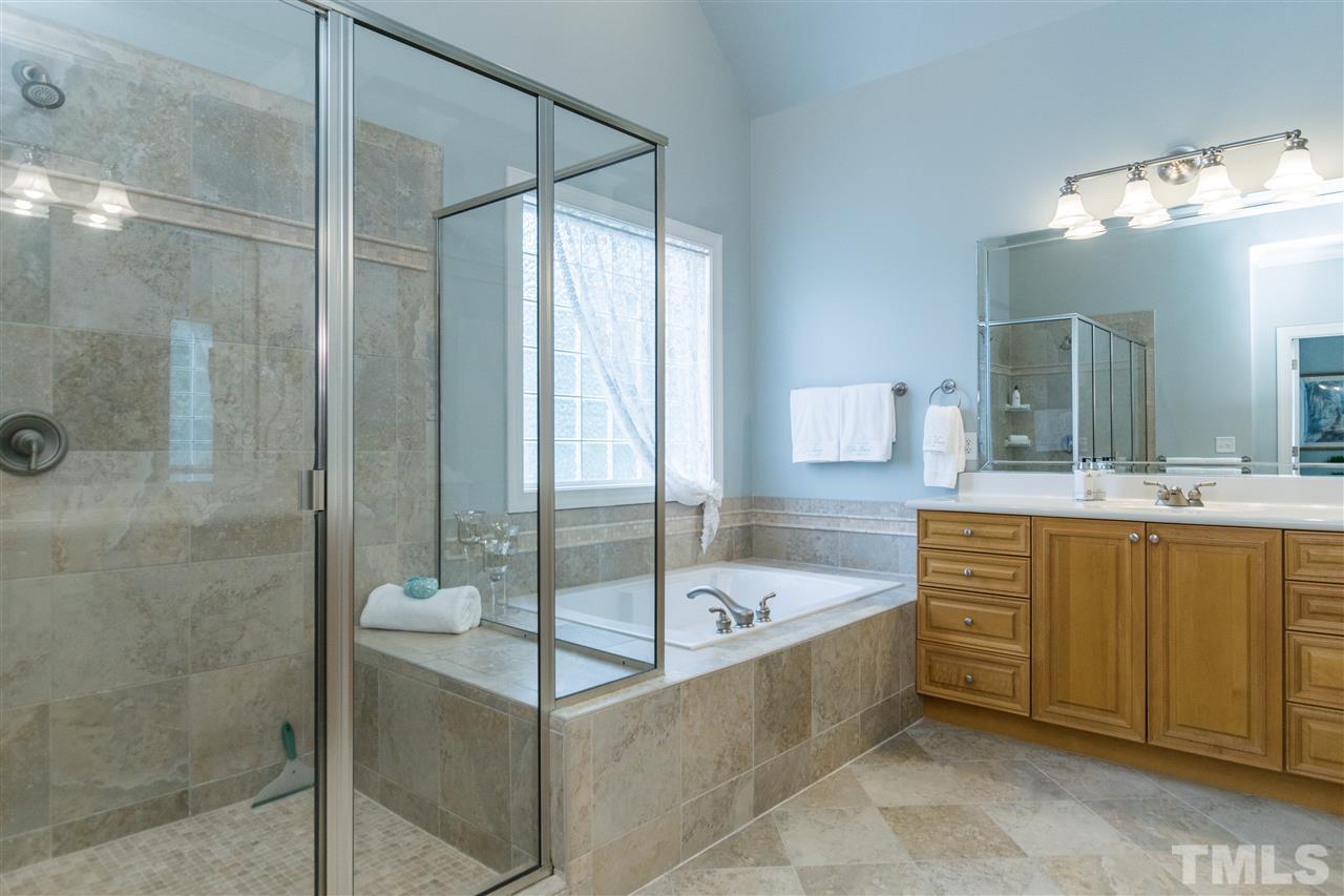3413 Spartina Court Raleigh, NC 27606 - Photo 18 of 25 a bathroom with a tub sink shower and mirror