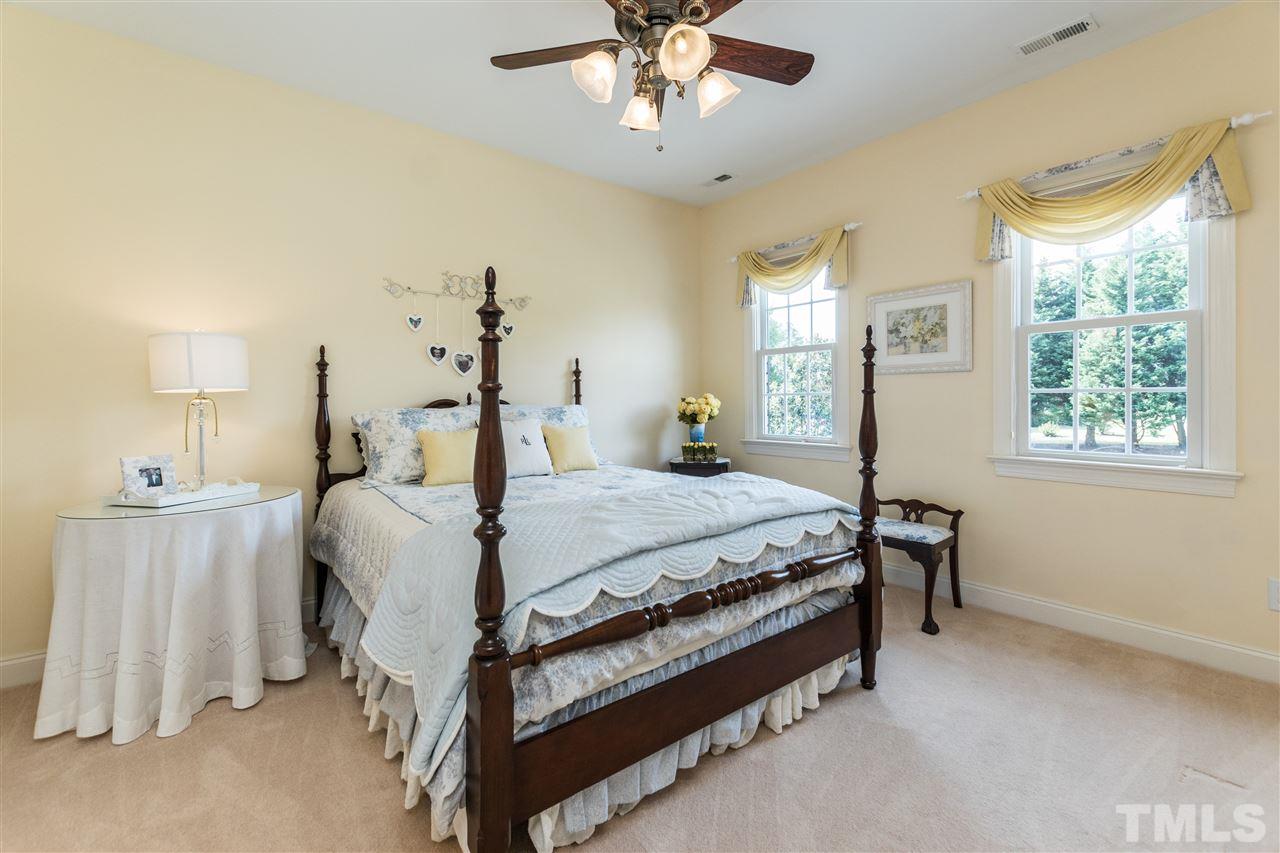 3413 Spartina Court Raleigh, NC 27606 - Photo 19 of 25 a bed sitting in a bedroom next to a window