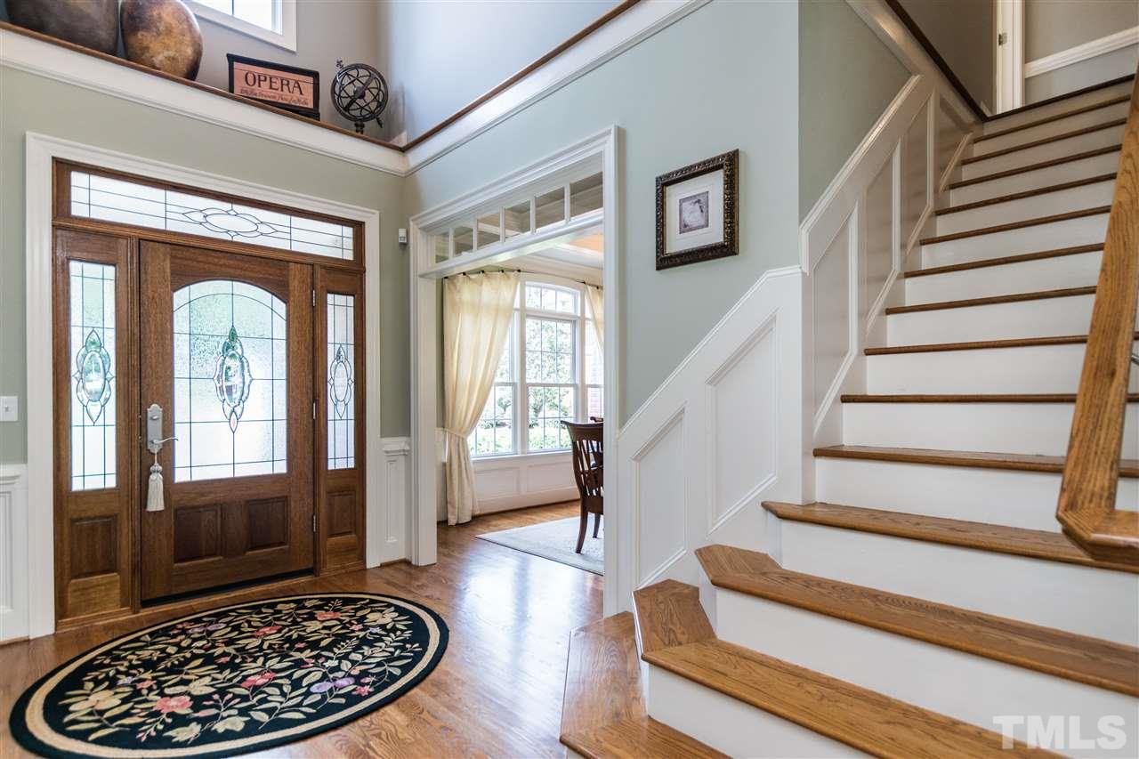 3413 Spartina Court Raleigh, NC 27606 - Photo 3 of 25 a view of staircase with a rug and a fireplace