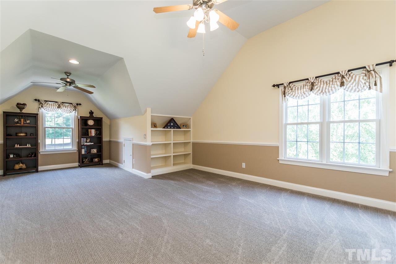 3413 Spartina Court Raleigh, NC 27606 - Photo 22 of 25 an empty room with fireplace and windows