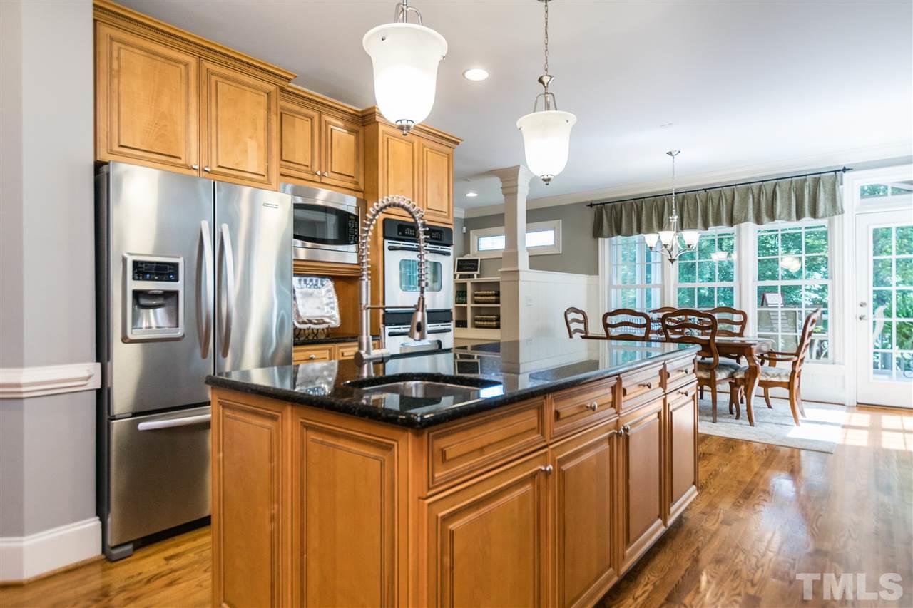 3413 Spartina Court Raleigh, NC 27606 - Photo 9 of 25 a kitchen with stainless steel appliances granite countertop a stove and a refrigerator