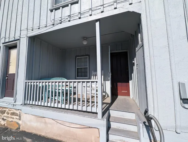 a view of a balcony with wooden floor