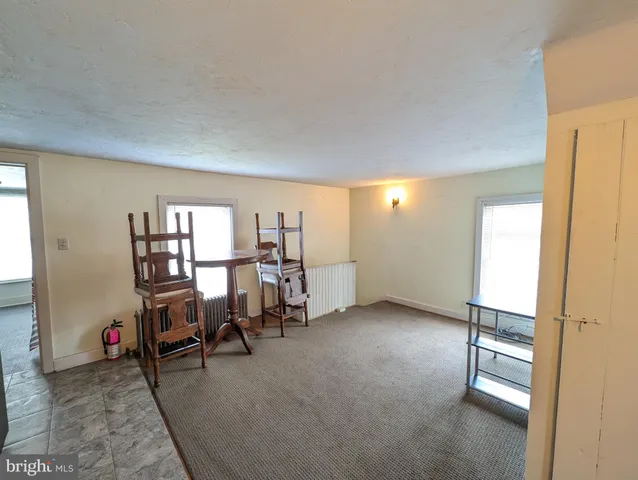 a view of a livingroom with furniture and a window