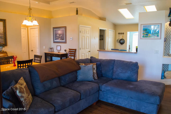 6130 Edison Street Cocoa, FL 32927 - Photo 11 of 15 a living room with furniture and a chandelier