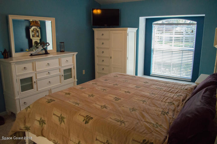6130 Edison Street Cocoa, FL 32927 - Photo 8 of 15 a bedroom with a bed and a dresser