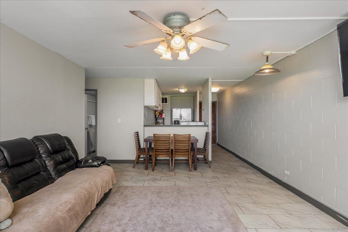 111 Kahului Beach Road, Unit B314 Kahului, HI 96732 - Photo 13 of 32 a living room with furniture and a chandelier
