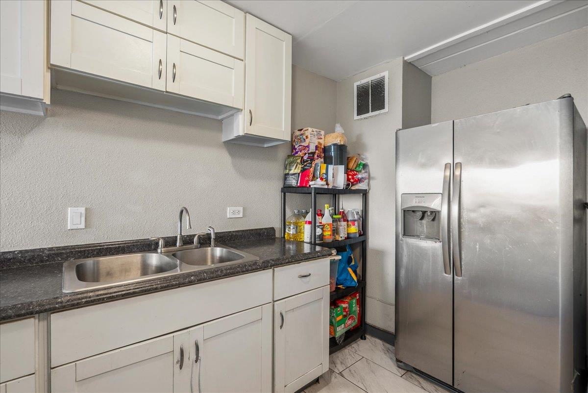 111 Kahului Beach Road, Unit B314 Kahului, HI 96732 - Photo 20 of 32 a kitchen with refrigerator and cabinets