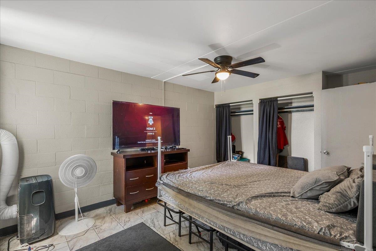111 Kahului Beach Road, Unit B314 Kahului, HI 96732 - Photo 22 of 32 a bedroom with a bed and a chandelier