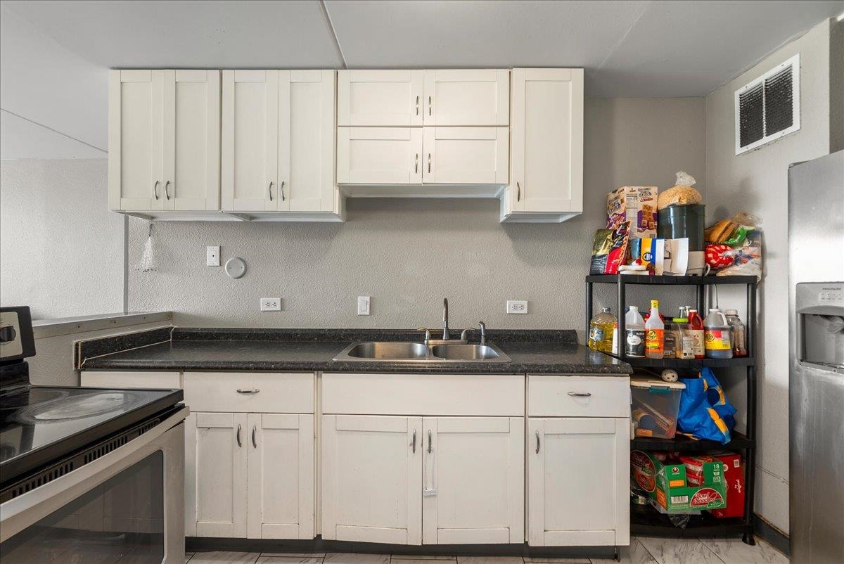 111 Kahului Beach Road, Unit B314 Kahului, HI 96732 - Photo 3 of 32 a kitchen with stainless steel appliances granite countertop a sink and cabinets
