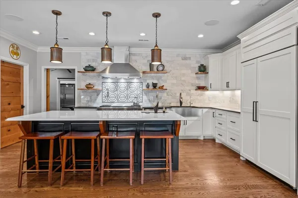 a kitchen with refrigerator and table