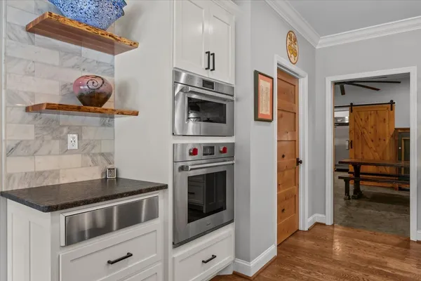 a kitchen with granite countertop a stove and a refrigerator