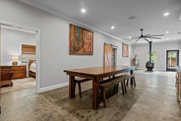 a view of a backyard with wooden fence and large trees