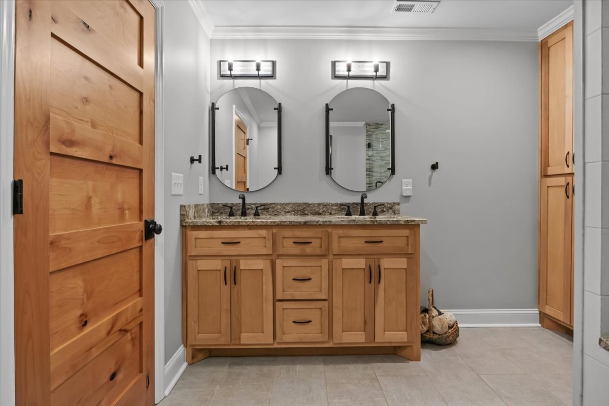 1355 Mitchell Road Pulaski, TN 38478 - Photo 51 of 95 a bathroom with a granite countertop sink and a mirror