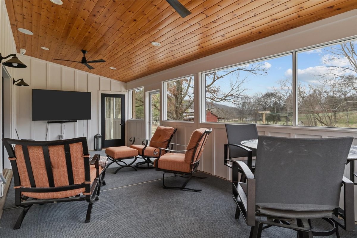 1355 Mitchell Road Pulaski, TN 38478 - Photo 59 of 95 a living room with furniture a flat screen tv and a floor to ceiling window