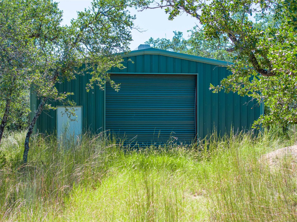 0 Post Oak Bend Loop Marble Falls, TX 78654 - Photo 18 of 18 a yellow house with green field in front of it