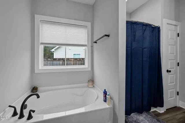 a bathroom with a tub and a window