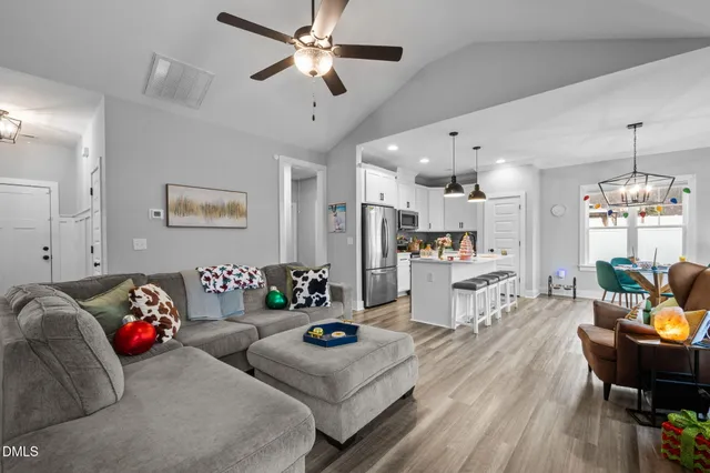 a living room with furniture and a chandelier