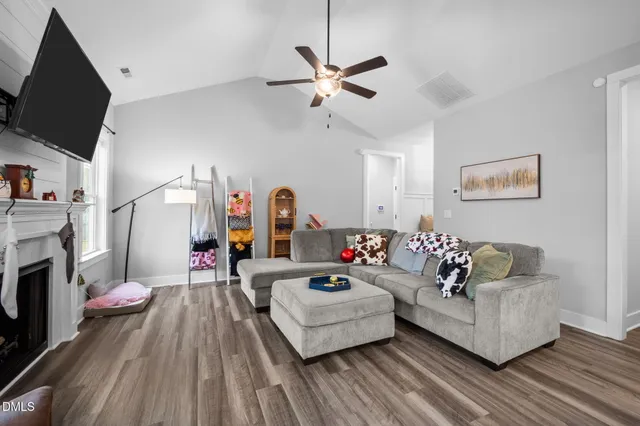 a living room with furniture and a fireplace