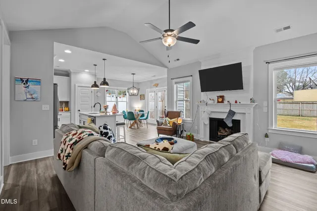 a living room with furniture a fireplace and a flat screen tv