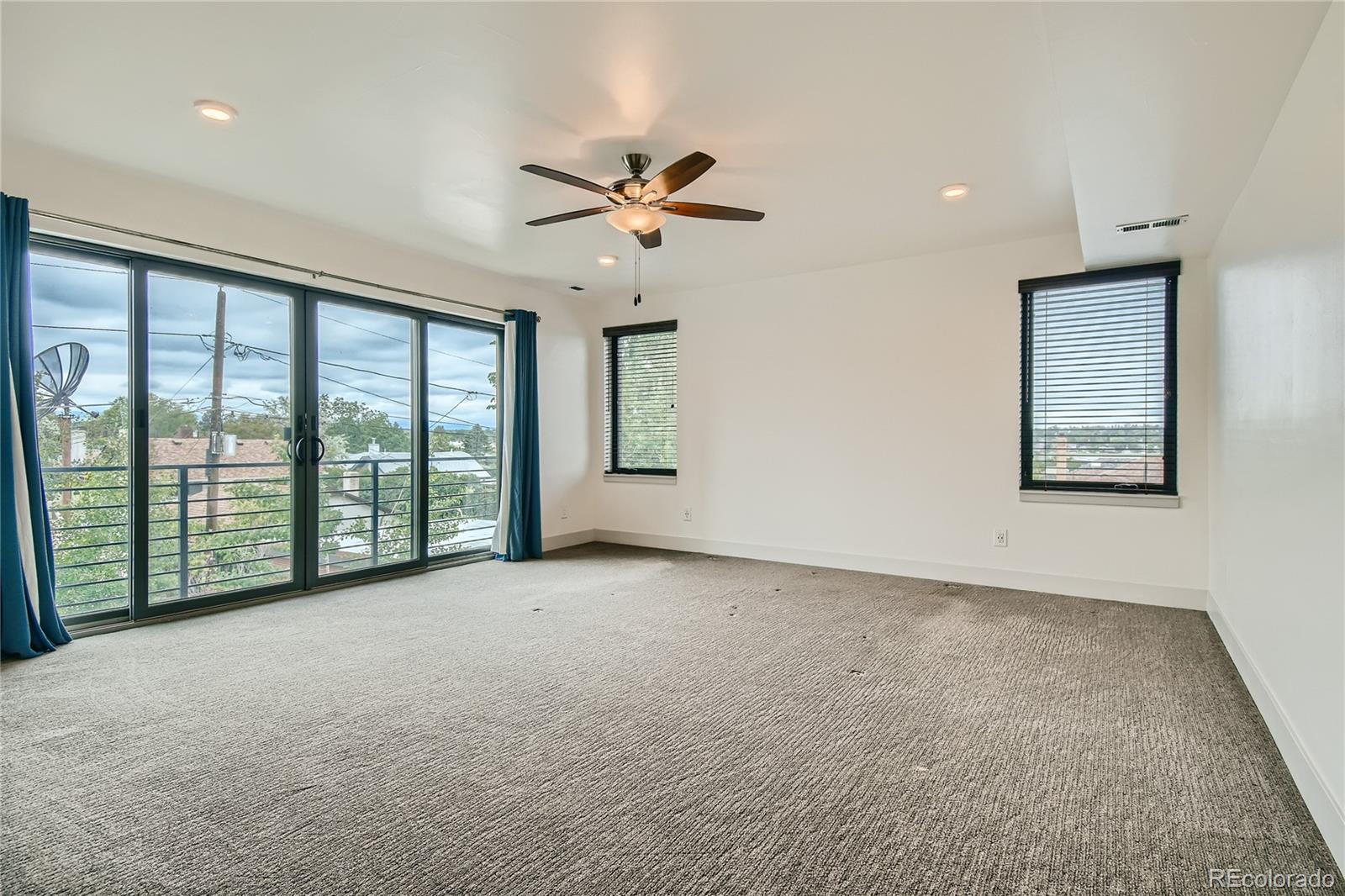 1609 Xavier Street Denver, CO 80204 - Photo 17 of 36 a view of a big room with windows and chandelier fan