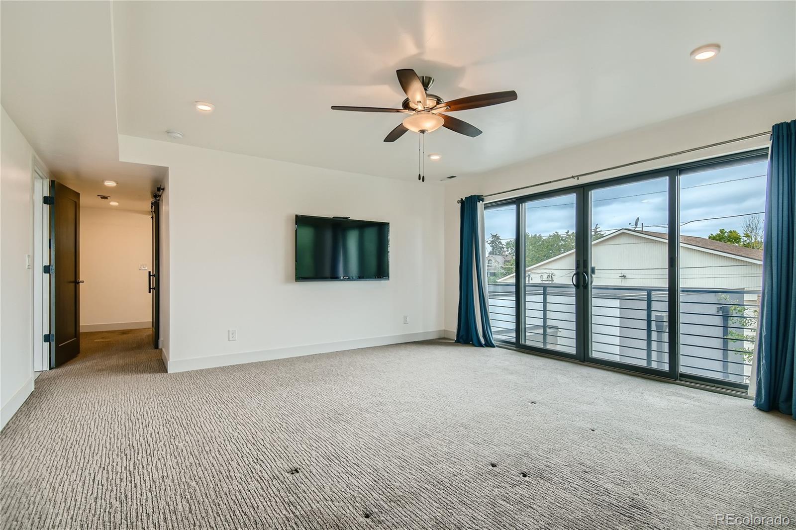1609 Xavier Street Denver, CO 80204 - Photo 19 of 36 a view of a livingroom with a ceiling fan and window