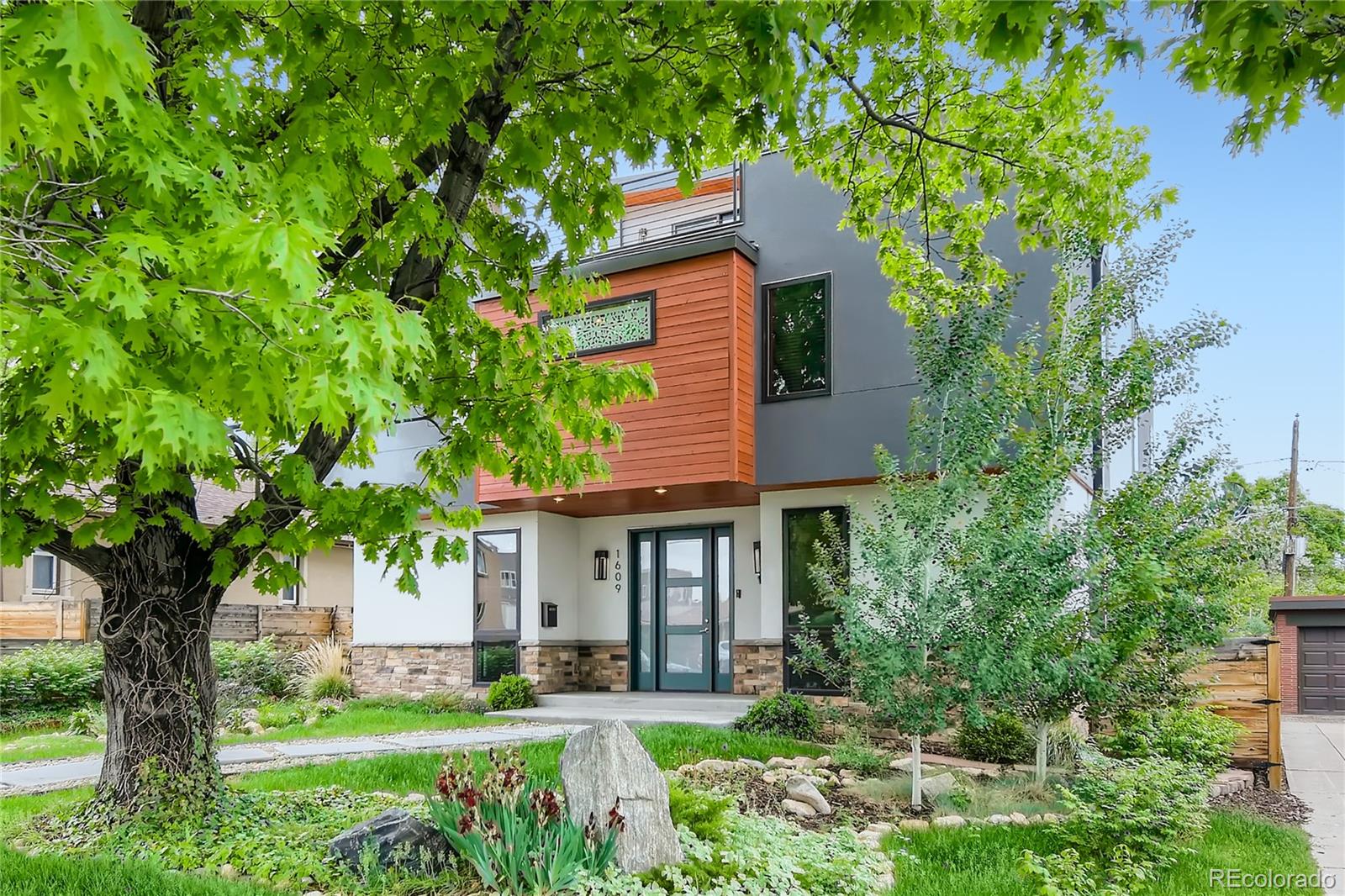 1609 Xavier Street Denver, CO 80204 - Photo 2 of 36 a front view of a house with a yard