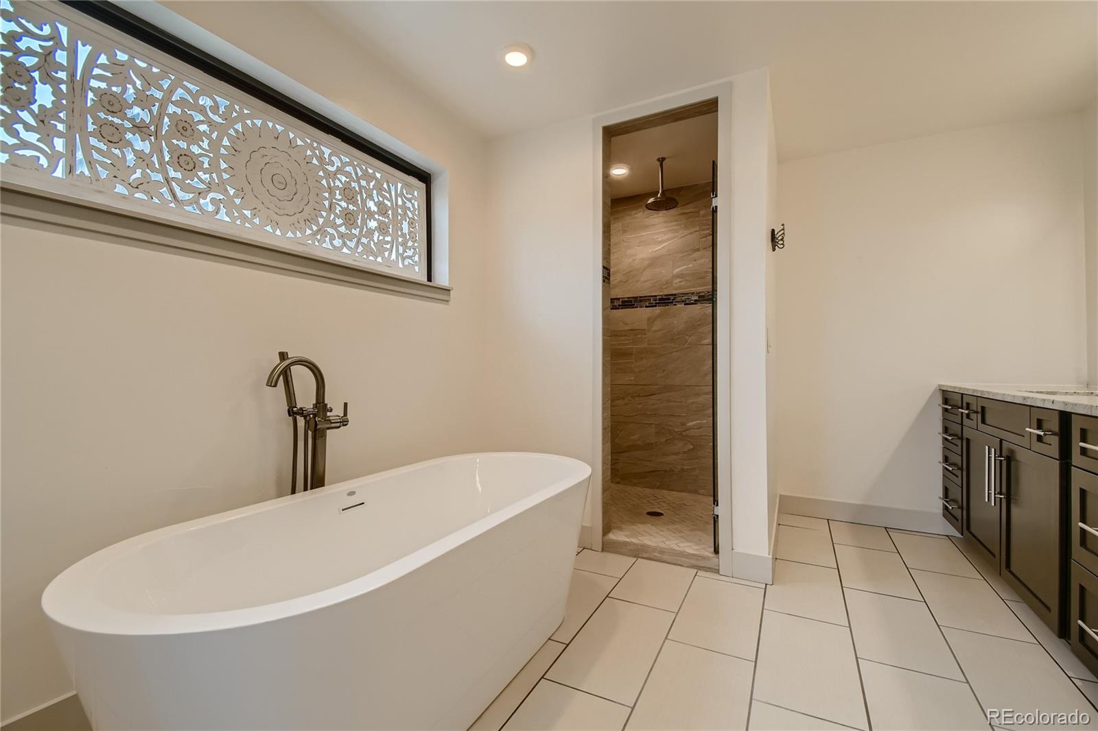 1609 Xavier Street Denver, CO 80204 - Photo 21 of 36 a bathroom with a bathtub and shower