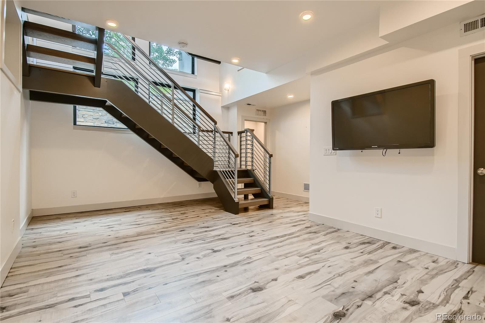 1609 Xavier Street Denver, CO 80204 - Photo 30 of 36 a view of a livingroom with wooden floor and stairs