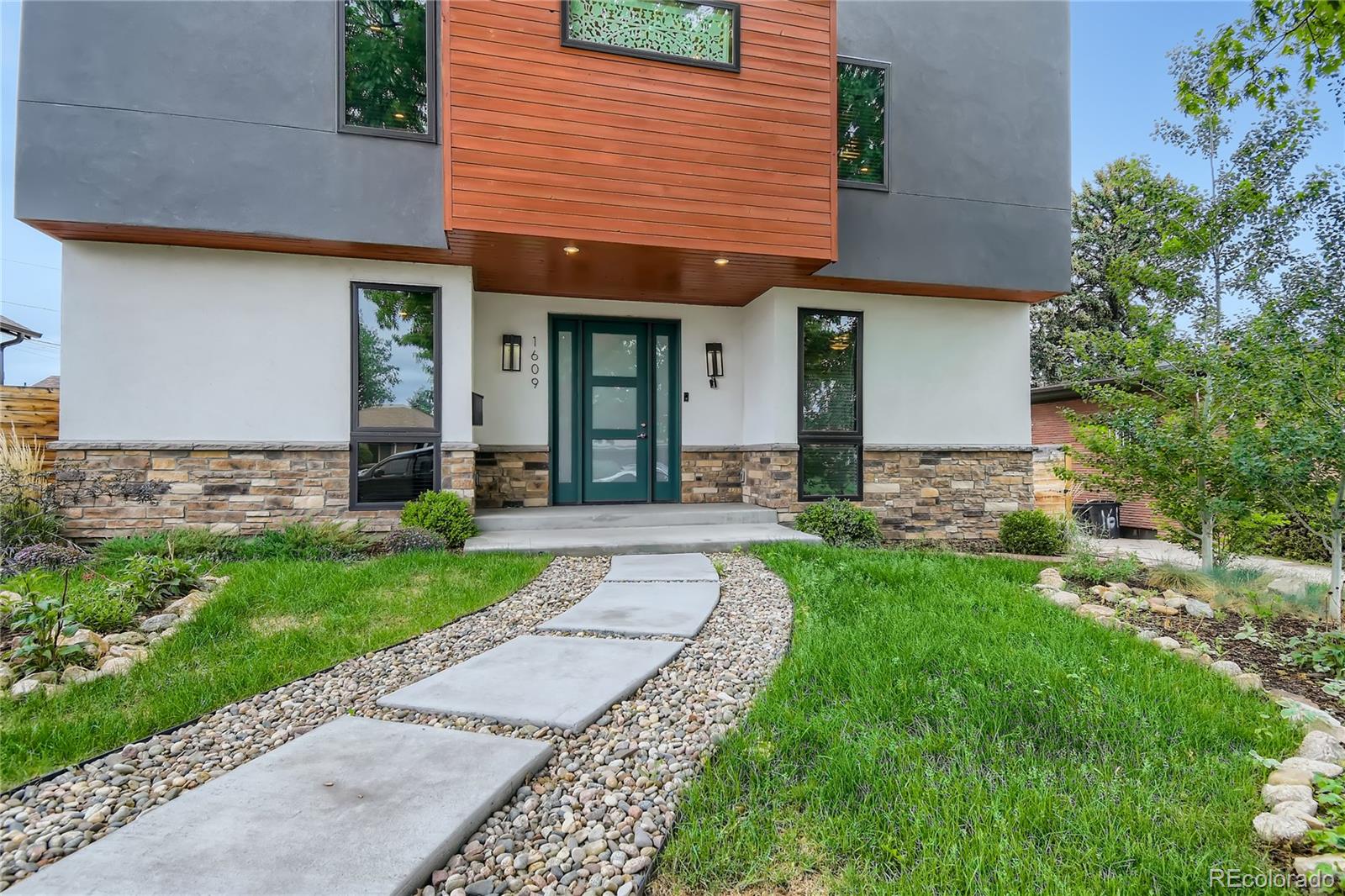 1609 Xavier Street Denver, CO 80204 - Photo 3 of 36 a front view of a house with garden