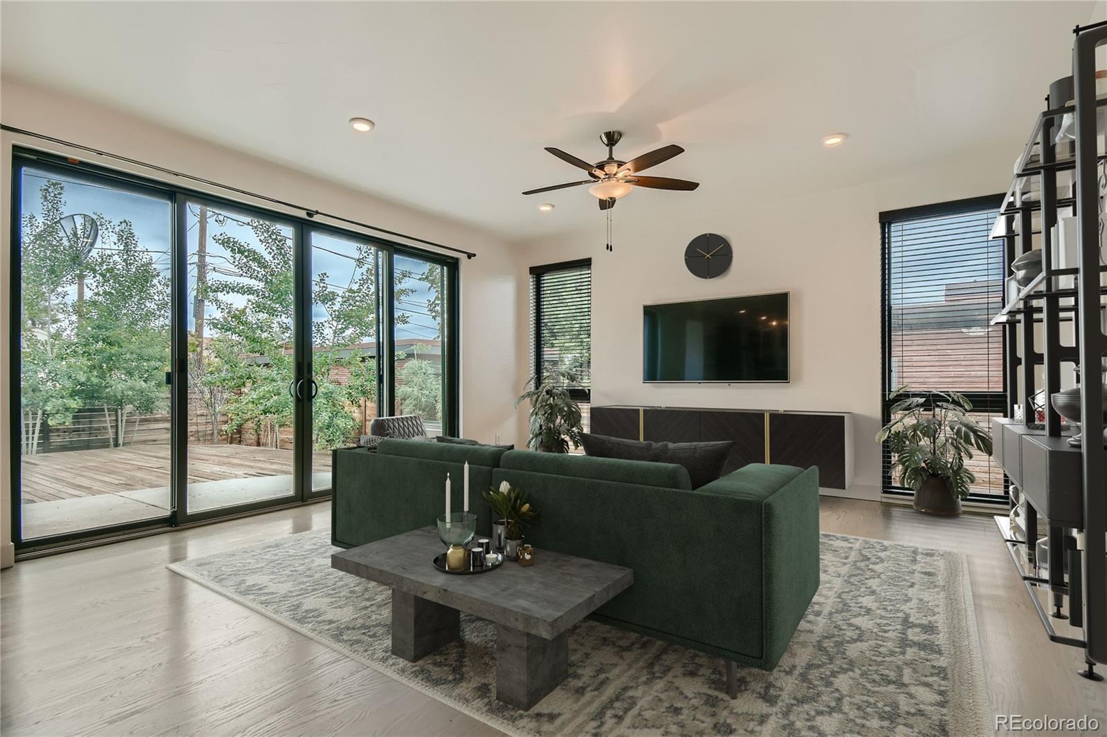 1609 Xavier Street Denver, CO 80204 - Photo 6 of 36 a living room with furniture a flat screen tv and a large window