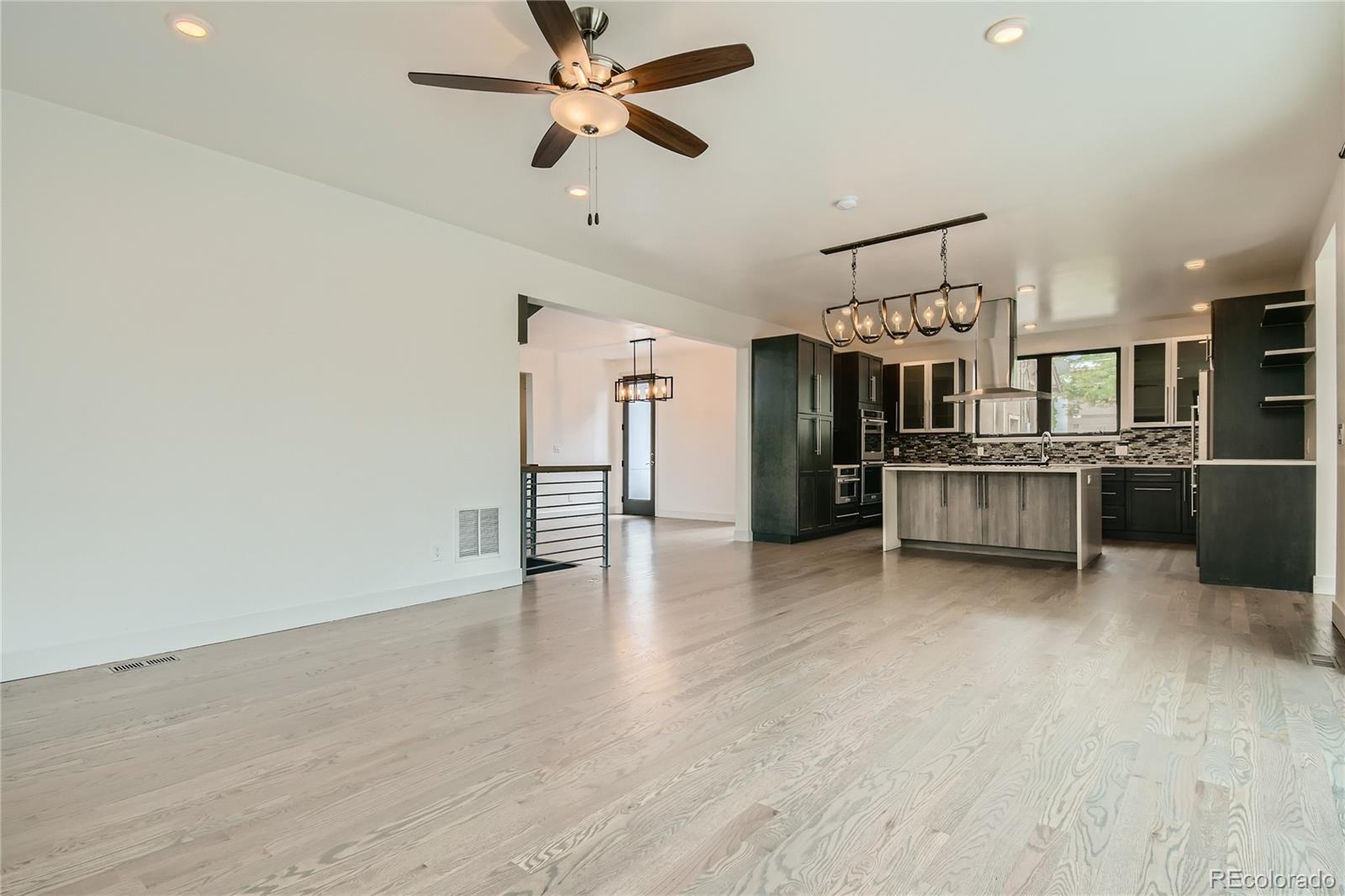 1609 Xavier Street Denver, CO 80204 - Photo 7 of 36 a view of a kitchen with a sink cabinets and wooden floor