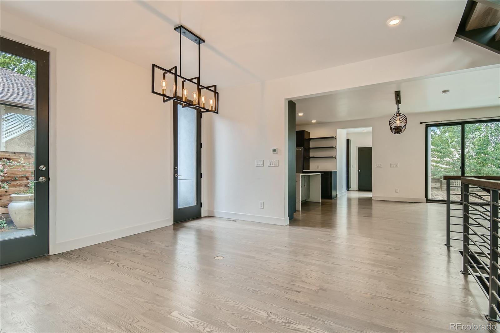 1609 Xavier Street Denver, CO 80204 - Photo 9 of 36 a view of a livingroom with wooden floor and a ceiling fan