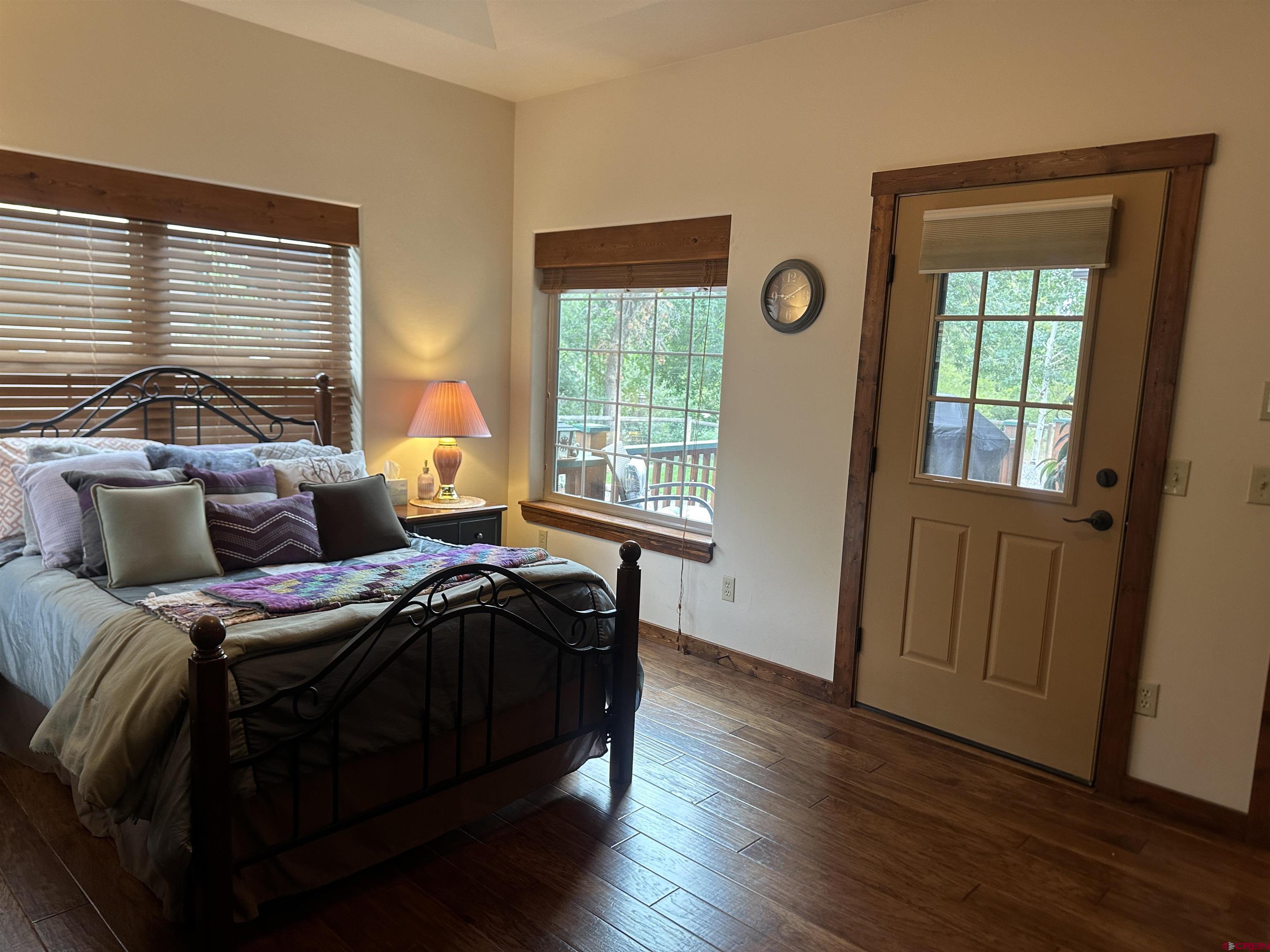 515 Southeast 2nd Street Cedaredge, CO 81413 - Photo 16 of 35 a bedroom with a bed and wooden floor