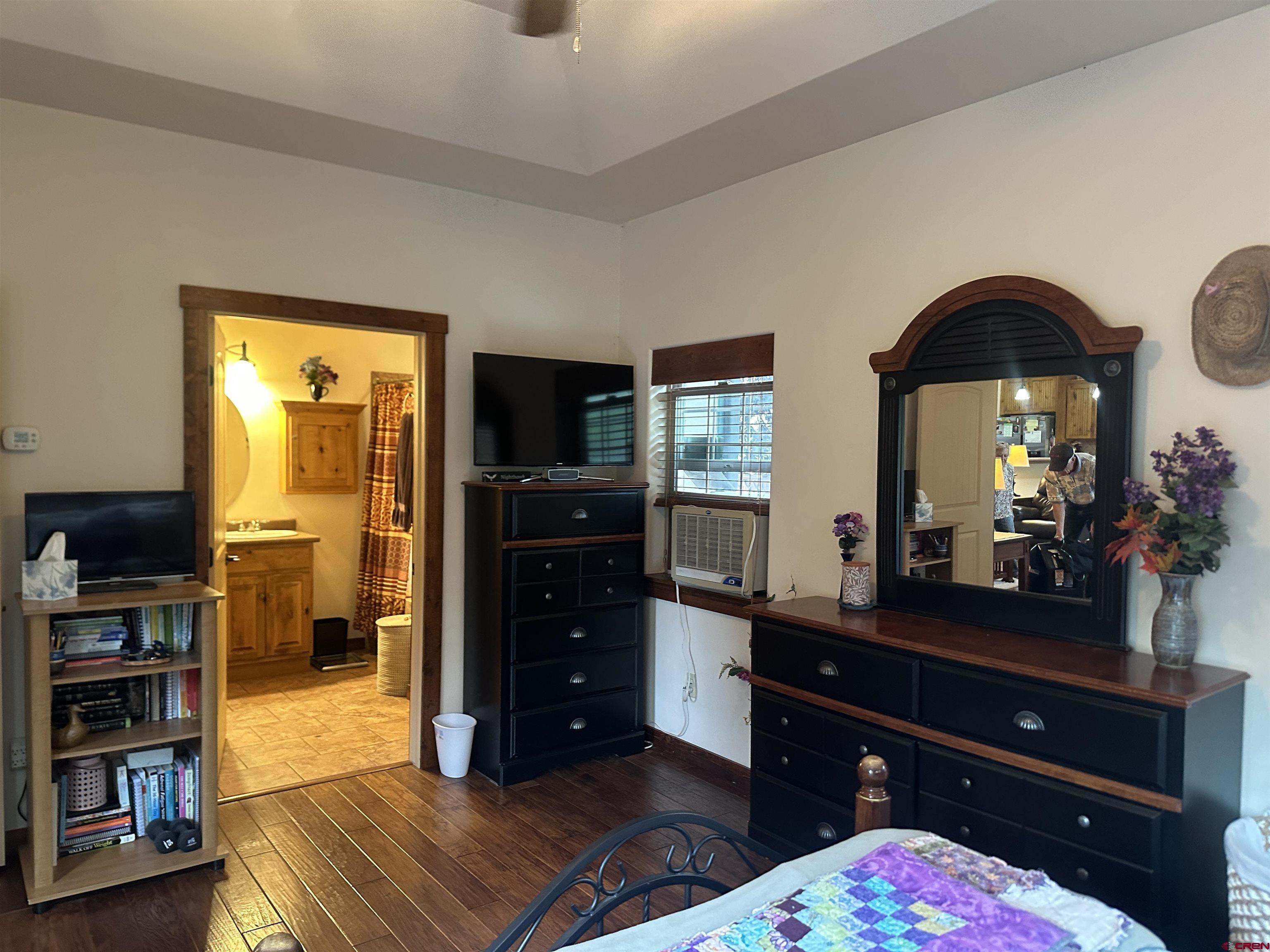 515 Southeast 2nd Street Cedaredge, CO 81413 - Photo 17 of 35 a bedroom with a bed and a television