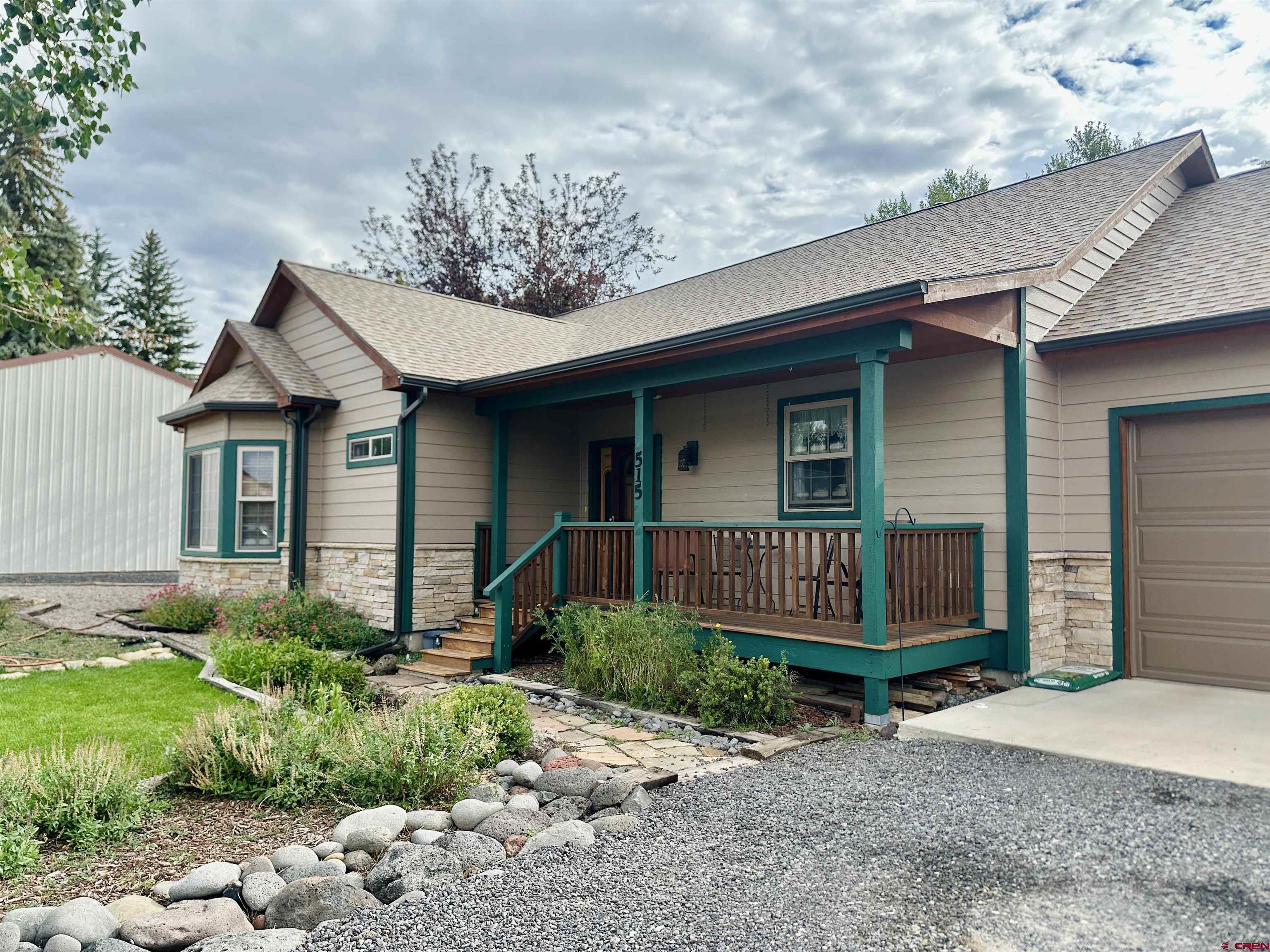 515 Southeast 2nd Street Cedaredge, CO 81413 - Photo 2 of 35 a front view of a house with garden