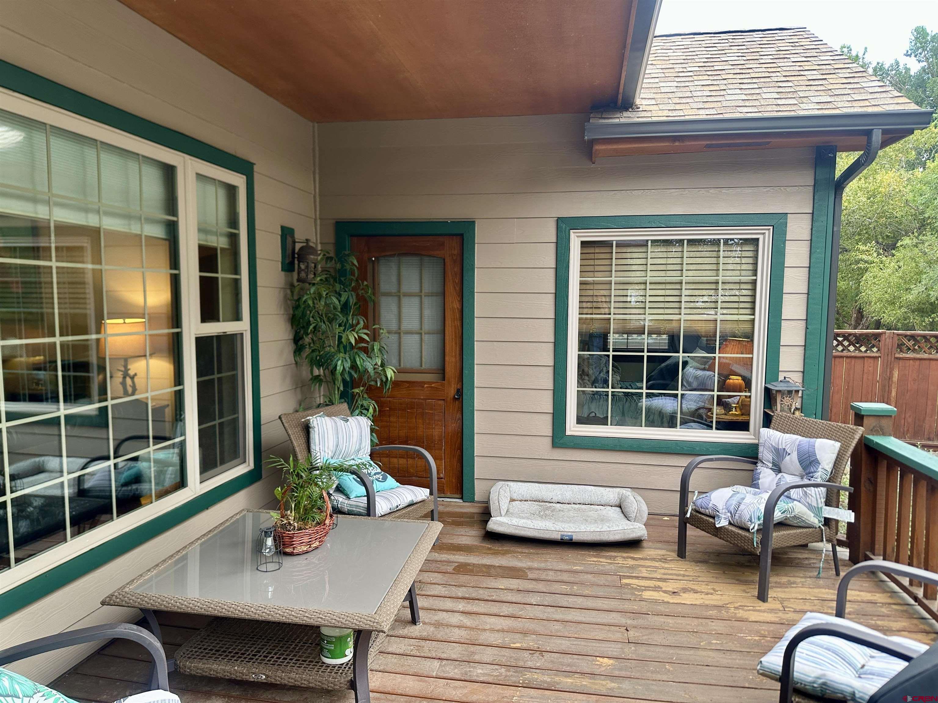 515 Southeast 2nd Street Cedaredge, CO 81413 - Photo 28 of 35 a view of a deck with table and chairs and wooden floor